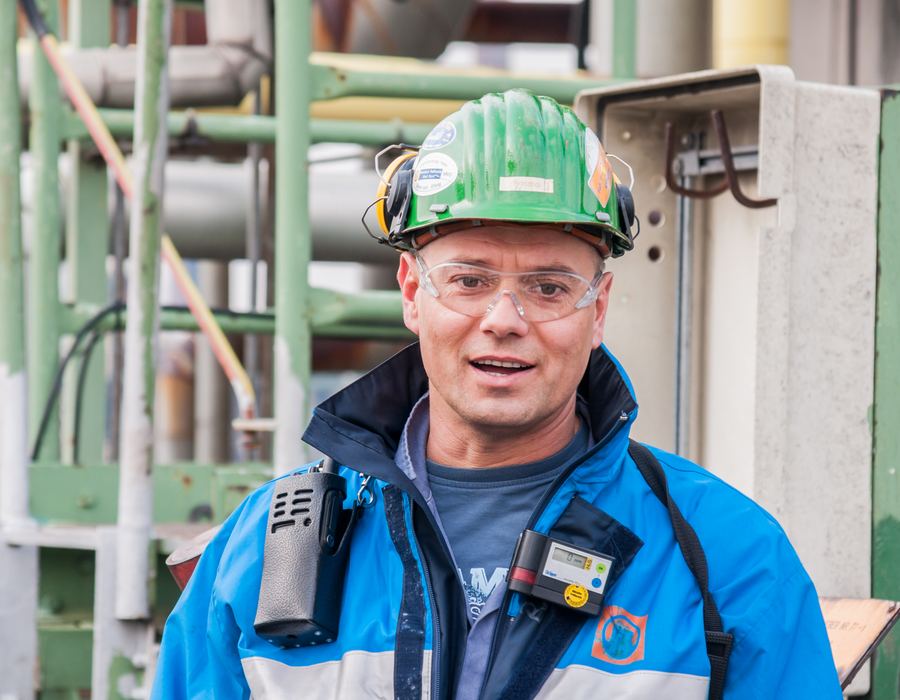 Field technician wearing safety helmet and glasses